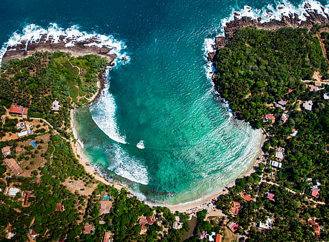 The horseshoe-shaped beach is a hub of surfing schools and cafes