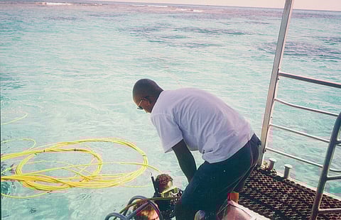 A guide overlooking prepartions for an undersea walk