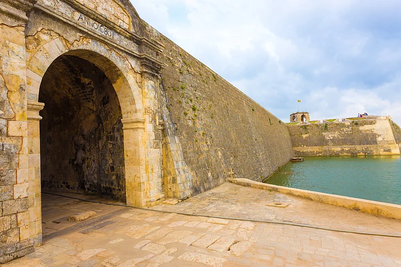 Jaffna Fort entrance and wall bordered by watery moat