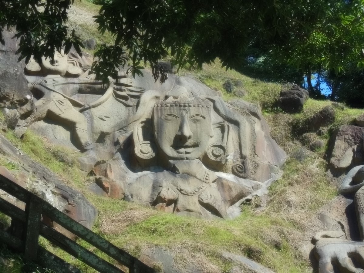 The huge vertical rock-cuts at Unakoti