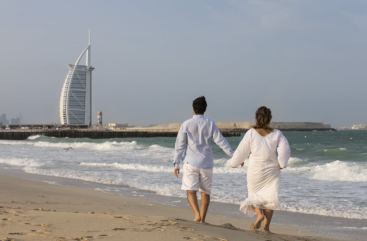 Couple walking on a beach in Dubai