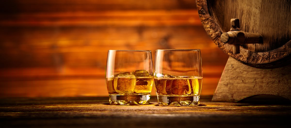 Shutterstock : Glasses of whisky kept within a distillery