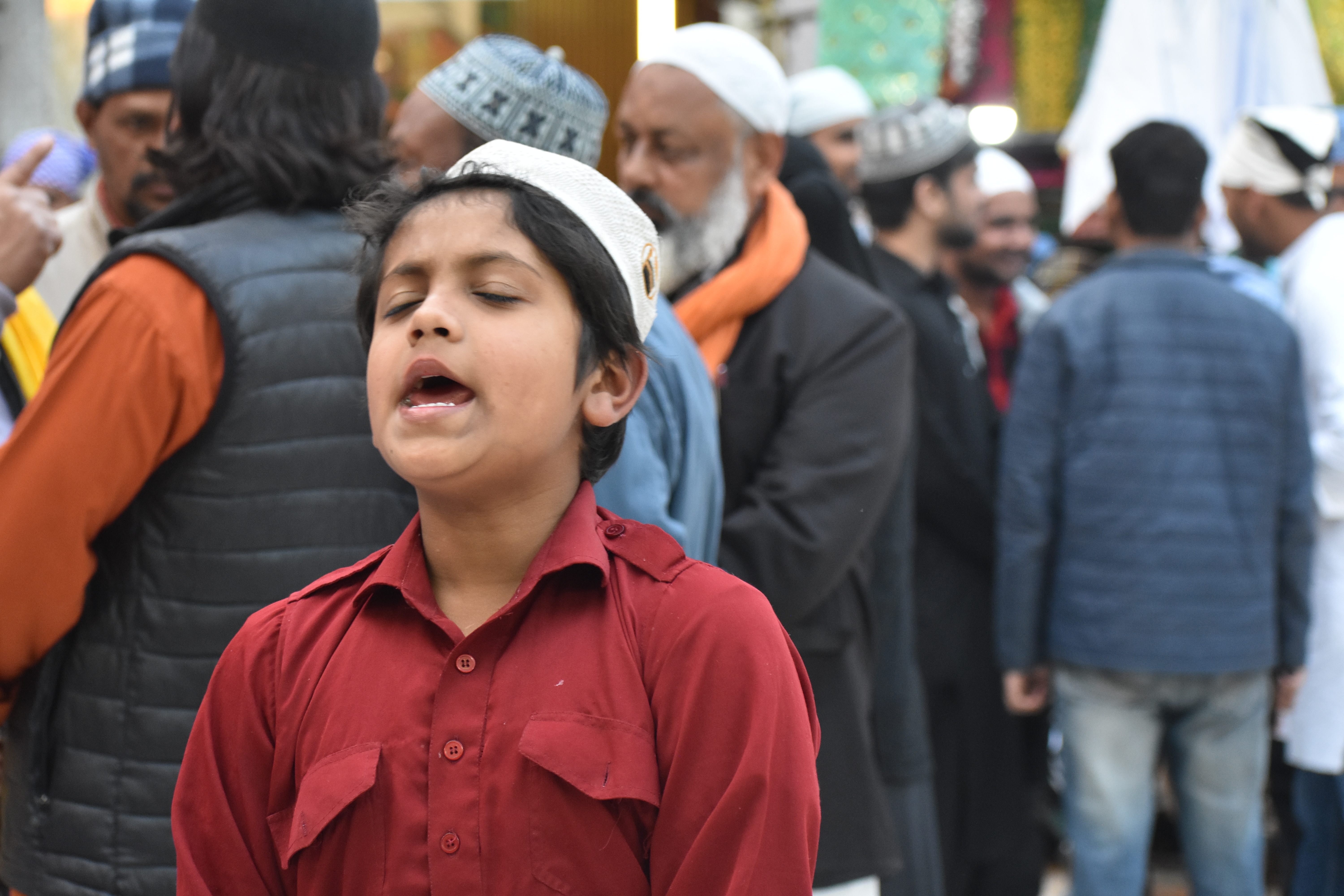 A teenager passionately recites a qawwali in praise and prayer unto the revered Sufi