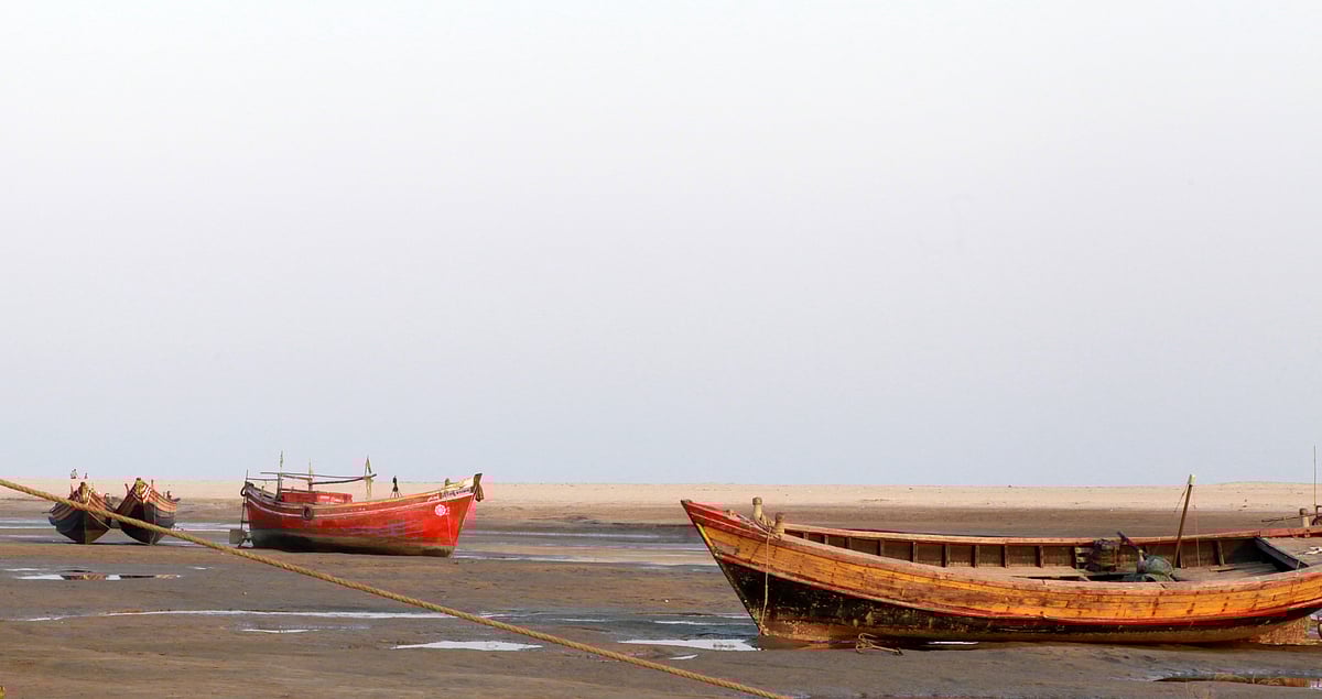 Wooden fishing boat on sand, Talasari Beach, India