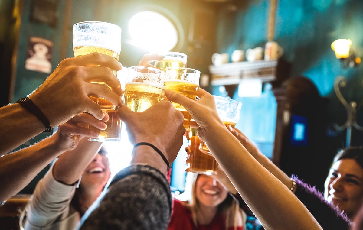 A group of people celebrates over beer