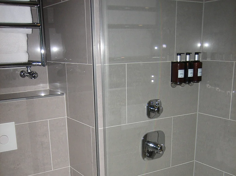 Refillable shampoo, soap and lotion containers in a hotel bathroom