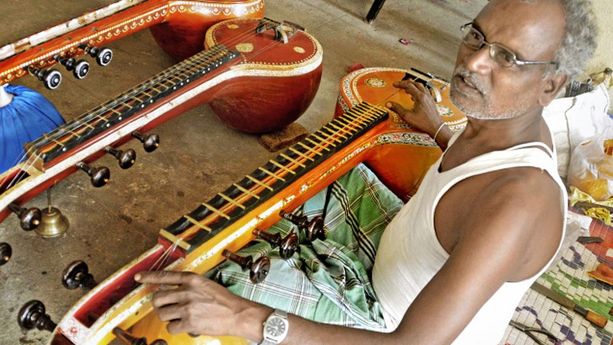 Tamarapalli Eswara Rao, a hereditary veena-maker, in Vizianagaram district repairing veenas on call at an apartment complex in Visakhapatnam
