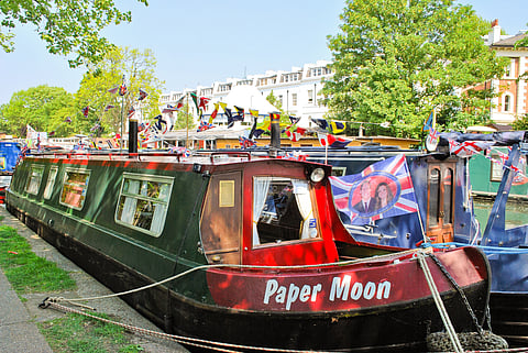 Details of the traditional narrowboats, decorated with flags and barge ware, moored in Little Venice for the annual Canalway Cavalcade