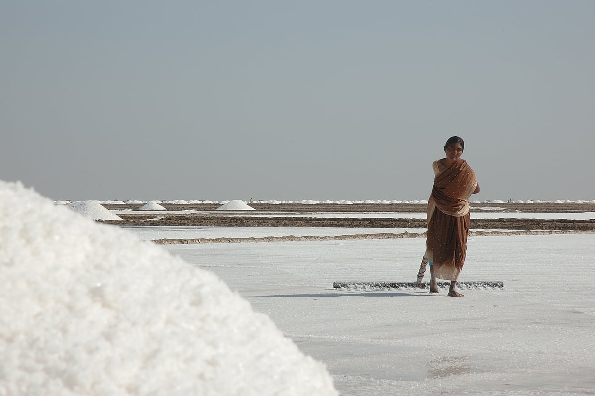 A woman working at a salt pan