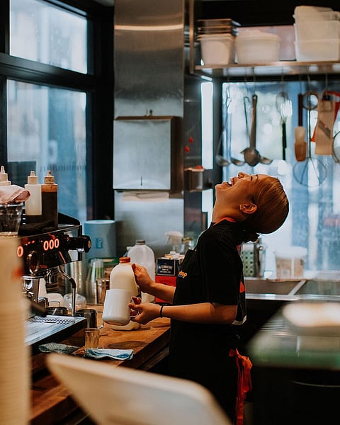 A happy barista at Warkop whipping up the day's brews