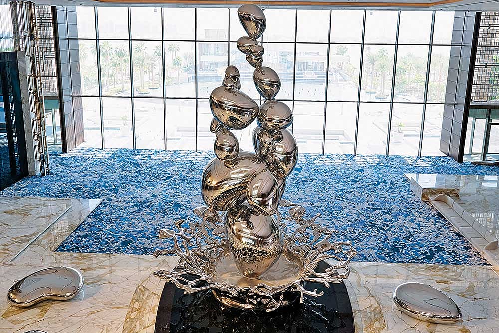 Droplets, an 11.5-metre tall stainless steel centrepiece that mimics the splatter of raindrops on the desert greets you in the lobby