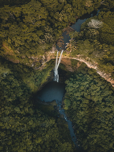 The beautiful Chamarel Waterfall, surrounded by ancient volcanic rock