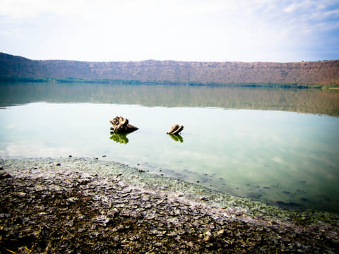 The crater's lip is filled with pebbles in various shades and shapes