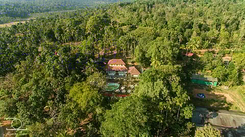 A 1946 ancestral home maintaining its beauty & architecture as a farm stay covered with tropical plants and green fields
