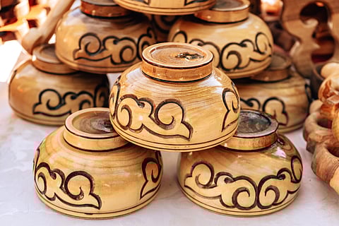 Wooden cups with the Kazakh national ornament in the stalls along Arbat street in the city of Shymkent