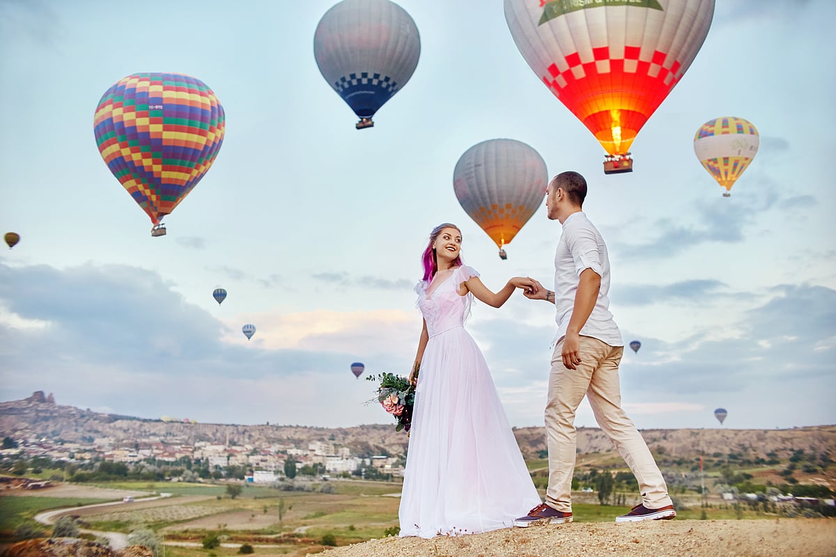 Couple in love stands on background of balloons in Cappadocia