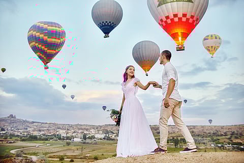 Couple in love stands on background of balloons in Cappadocia