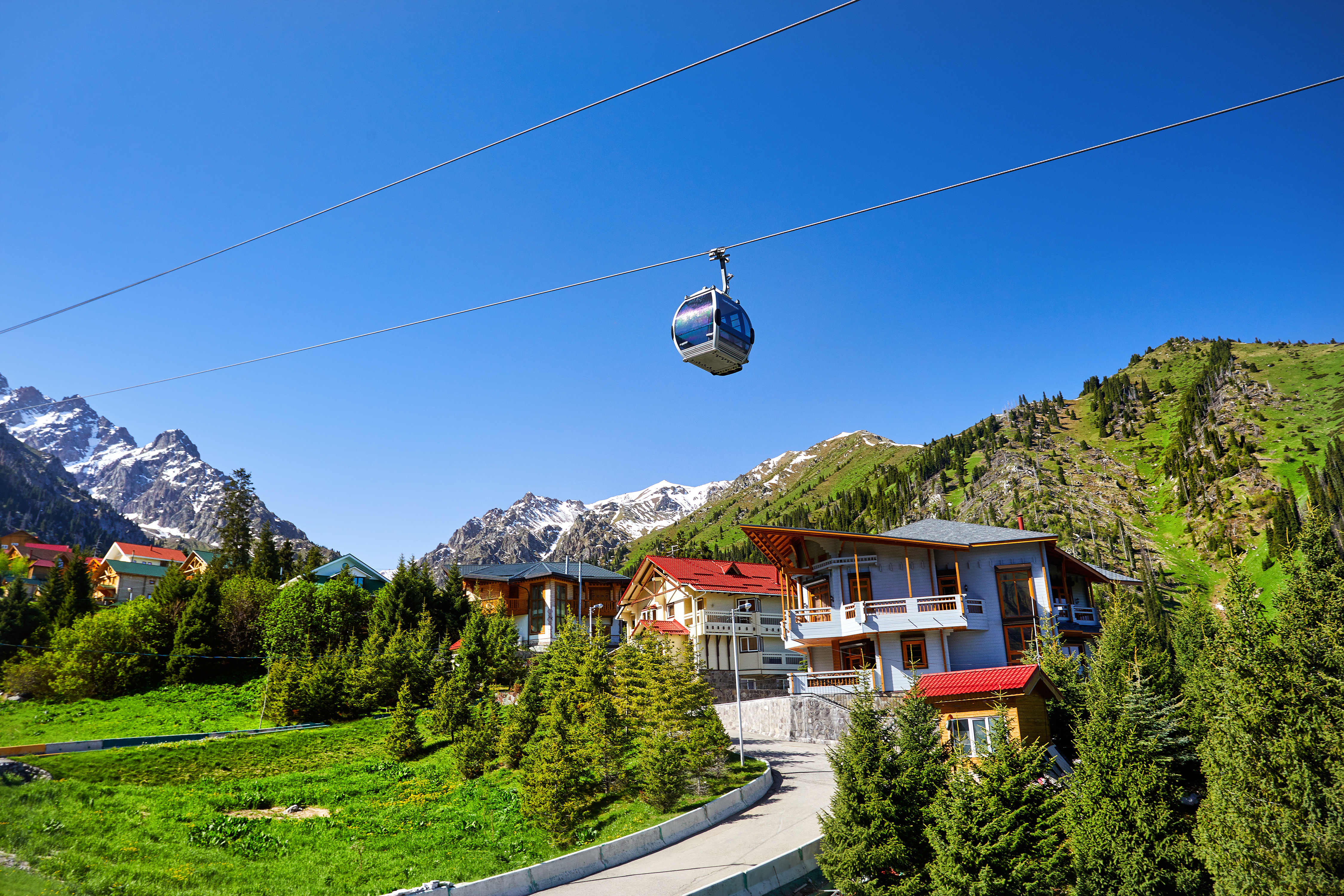 Cable car and cottages in the mountain ski resort Chimbylak in Almaty
