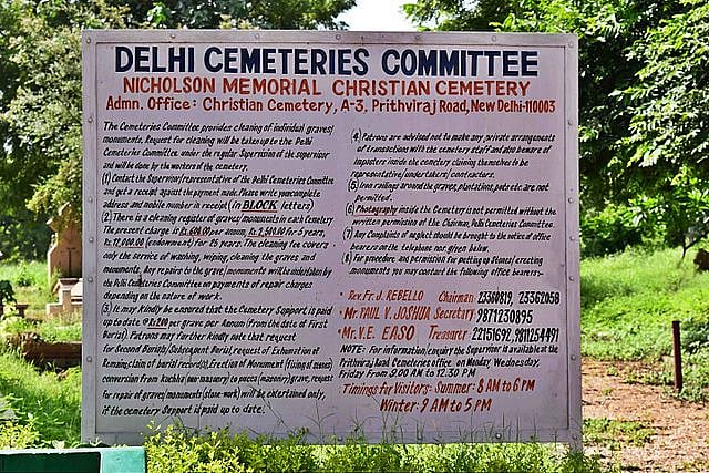A board about the cemetery and timings