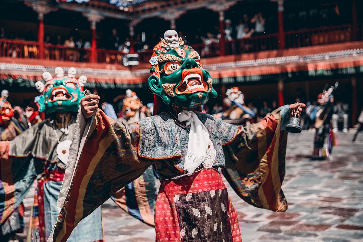 The performers wear magnificent brocade robes and execute a unique masked dance