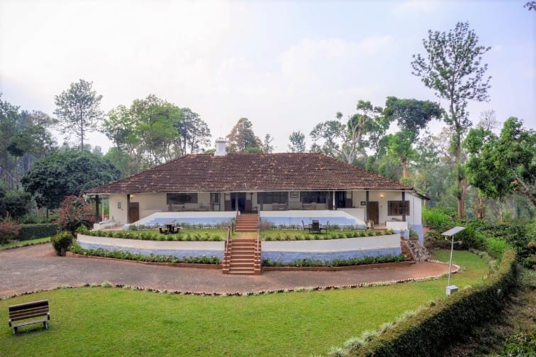 At Woshully Bungalow, the façade is distinctly Coorg, with a long, tiled verandah suggestive of the ainmane