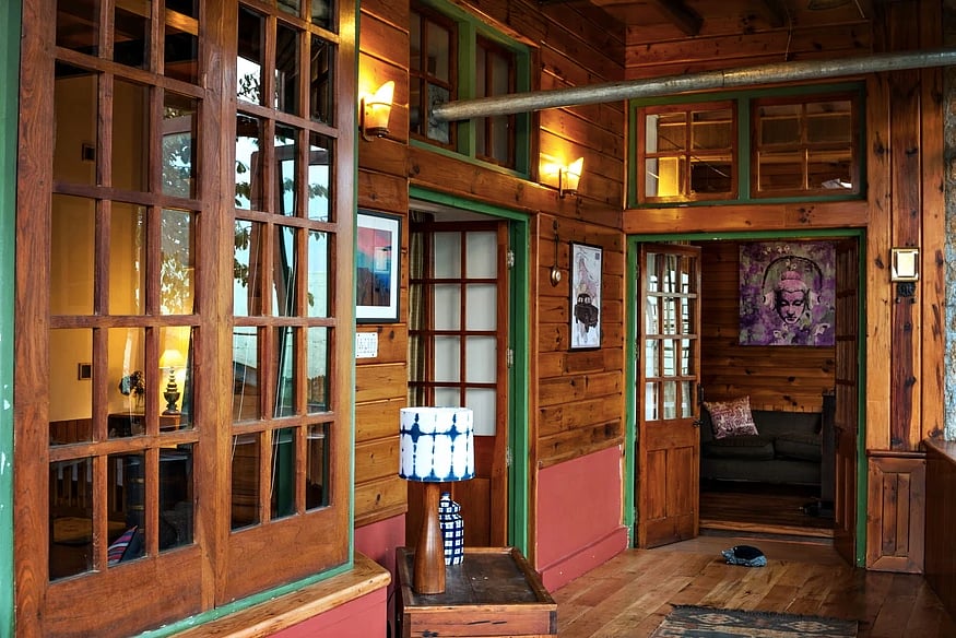 The sleek two-bedroom Manali guesthouse is made of Burma teak, English oak, and pine wood