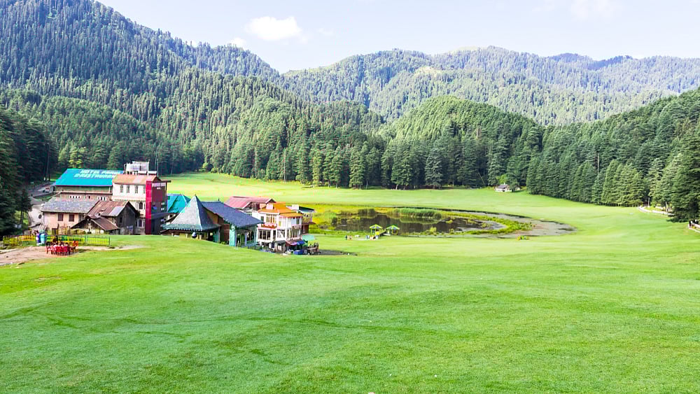 The meadow of Khajjiar is surrounded by thick forests
