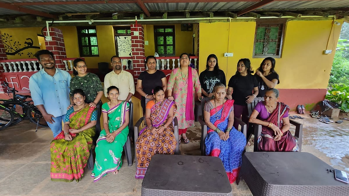 Guests and the homestay staff posing for a photo