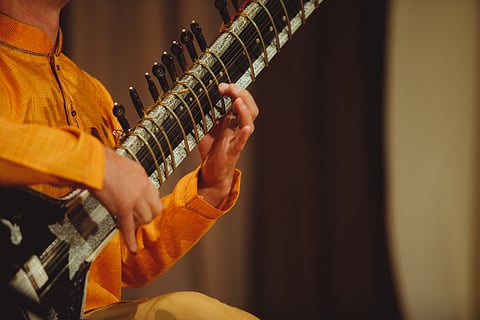 Immerse in the strains of the sitar at a classical music concert