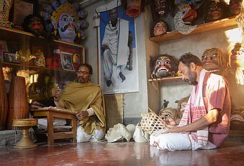 Hemchandra Goswami, who is widely acclaimed for his extraordinary skills of mask making, absorbed in his creation at Chamaguri Satra in Majuli, Assam