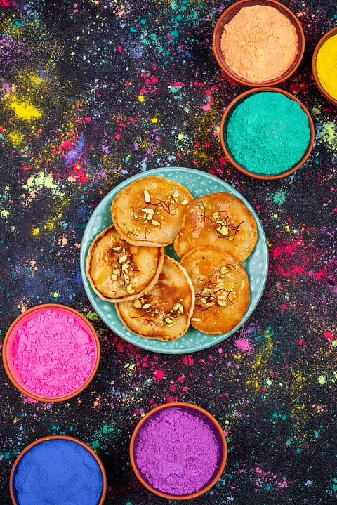 Malppua being served on the day of Holi