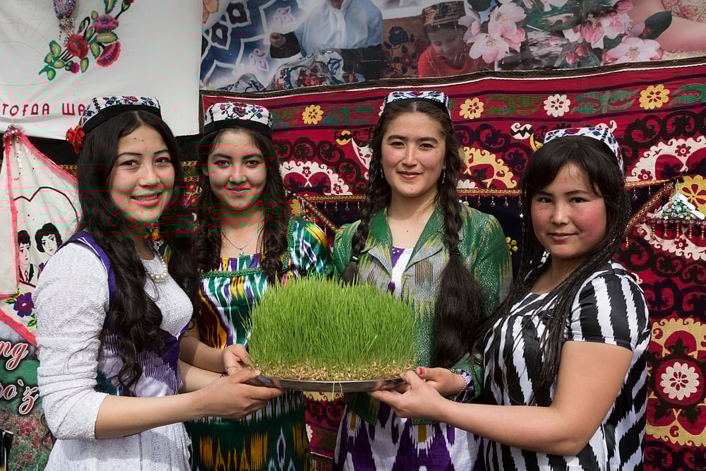 Young girls with sprouted grains of wheat for Sumalak, the festival of Nowruz in Termez, Uzbekistan