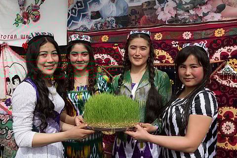 Young girls with sprouted grains of wheat for Sumalak, the festival of Nowruz in Termez, Uzbekistan