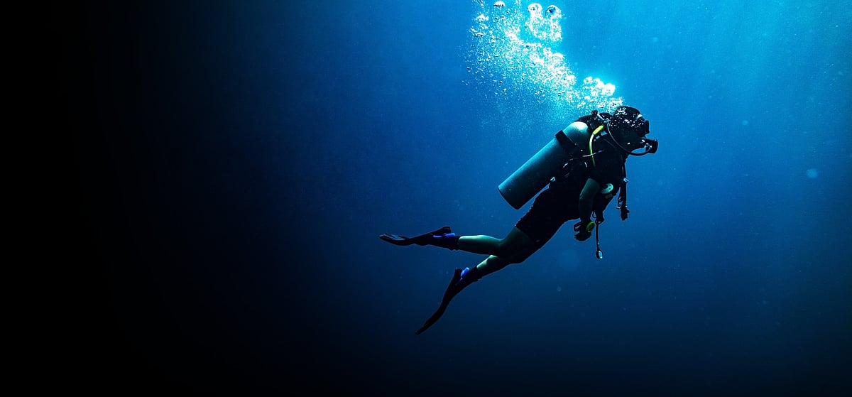 Scuba divers carry a compressed air tank on their body and breathe through a mouthpiece attached to the tank