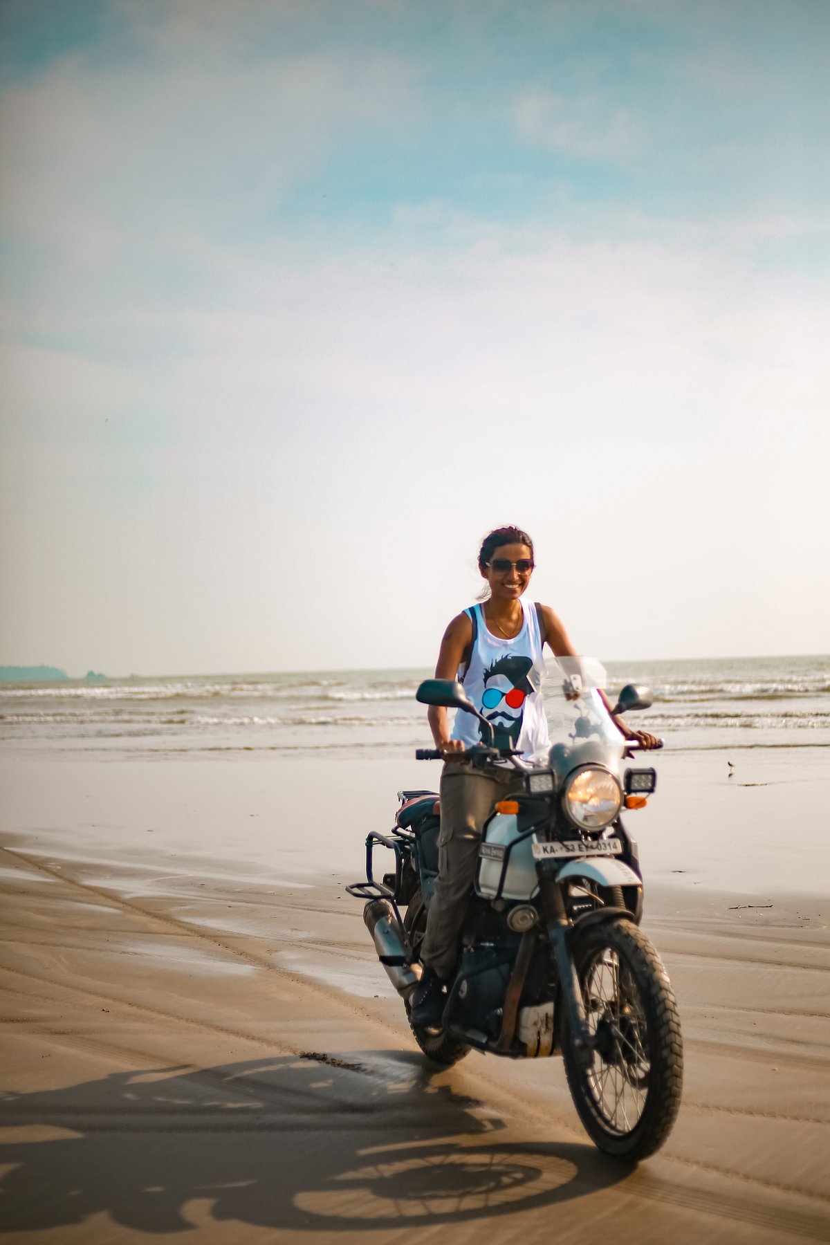 Mouna riding her Royal Enfield Himalayan motorbike on Muzhappalingad beach in Kerala