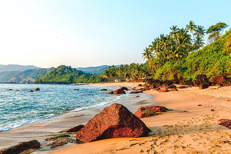Sunset views at Cola beach are particularly spectacular with vibrant colors reflecting off the sand and streams