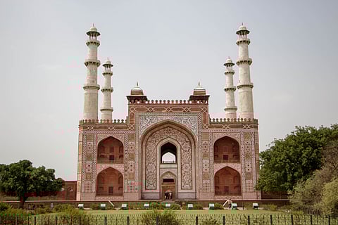 The deep red sandstone of Akbar's Tomb is etched with white marble