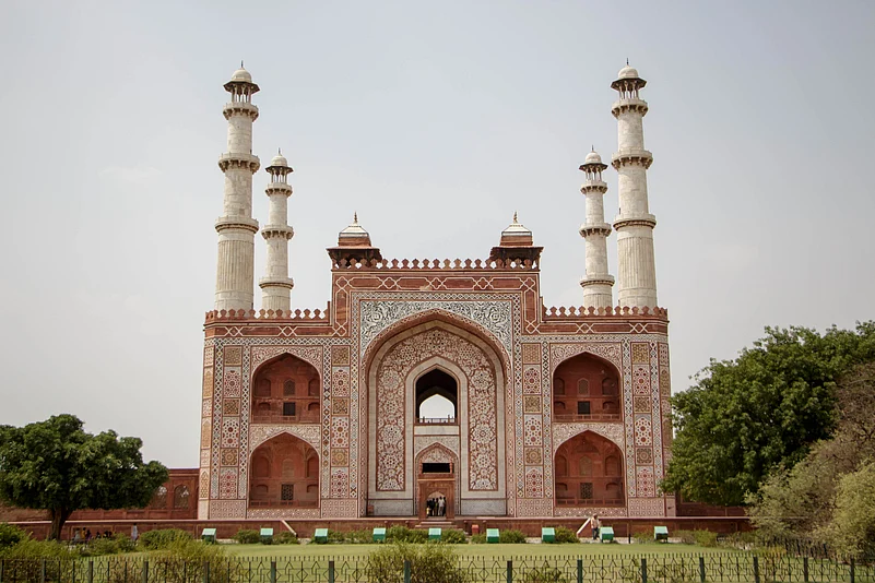 The deep red sandstone of Akbars Tomb is etched with white marble