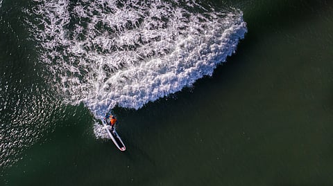 Surfing is a popular water activity at Kovalam Beach