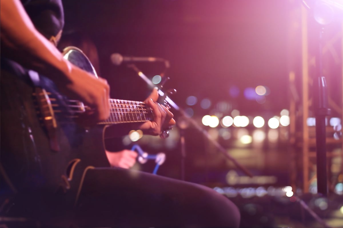 A rock guitarist getting ready for a gig