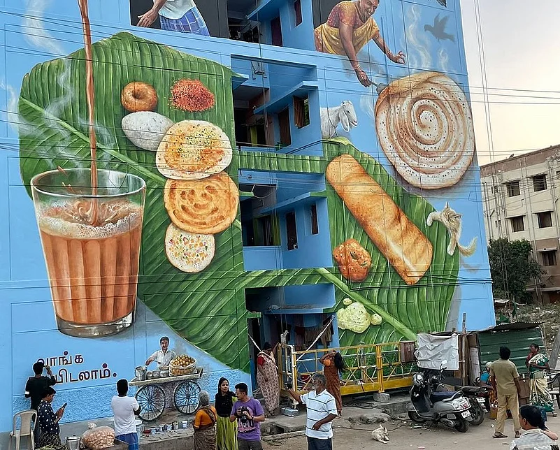 A crowd gathers to take photos of the mural