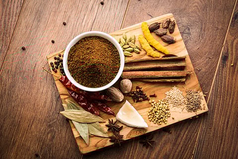 Indian Garam masala powder in bowl and it's ingredients colourful spices