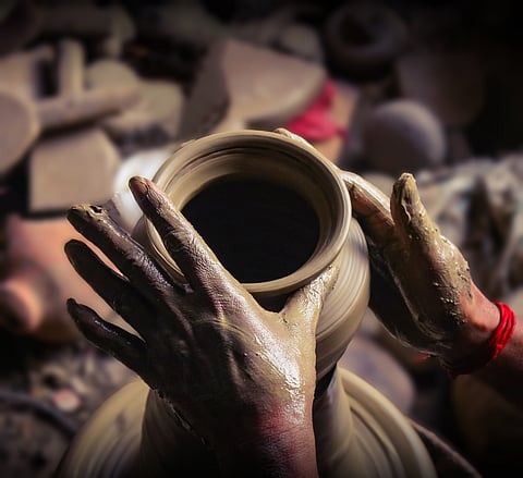 A potter at work on a terracotta pot