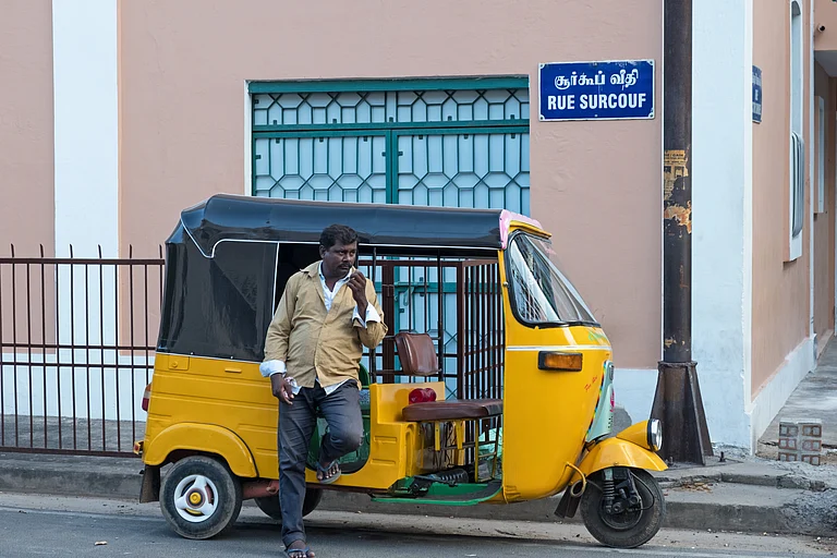 An auto rickshaw driver awaiting custom in the French quarter - pjhpix/Shutterstock