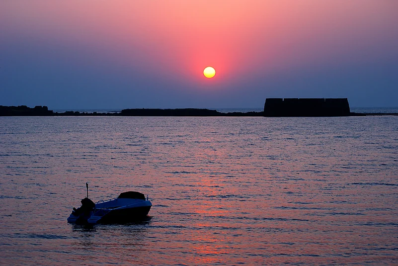 A glorious sunset behind the historical Kolaba Fort