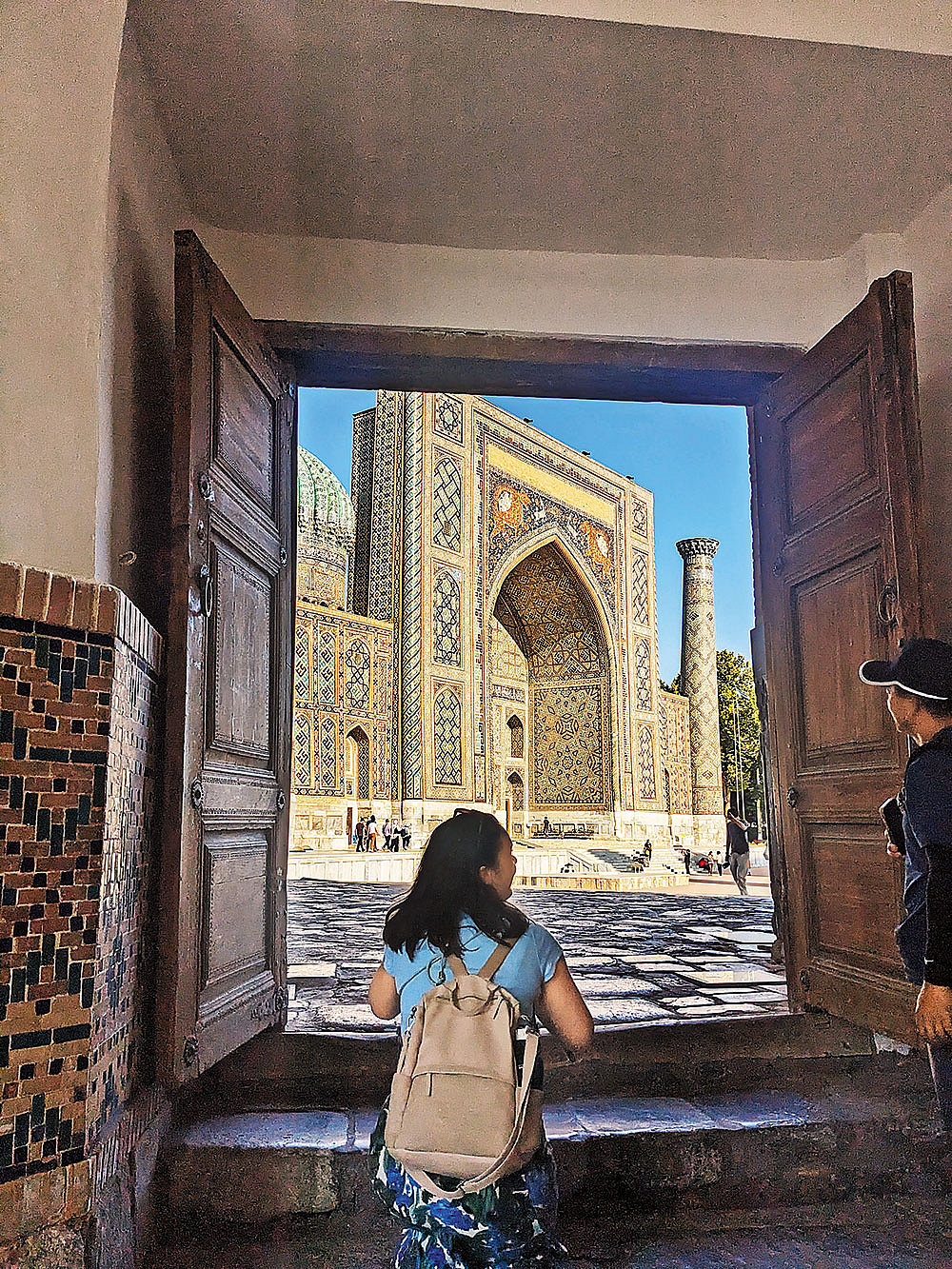 Pauline, a friend made on the road, looks out to the Sher Dor madrasa