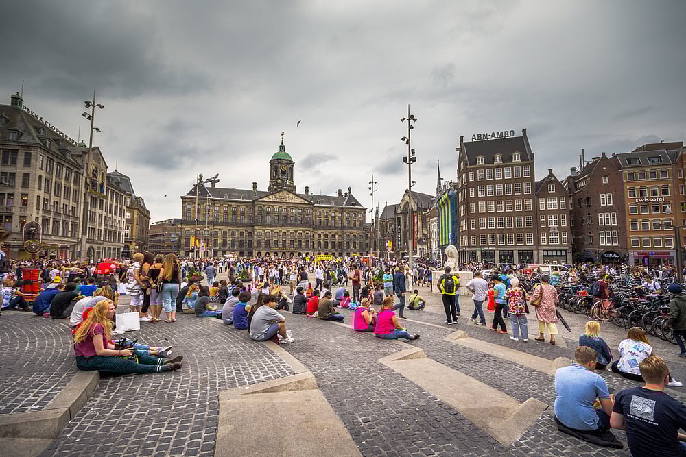 People throng Dam Square in Amsterdam