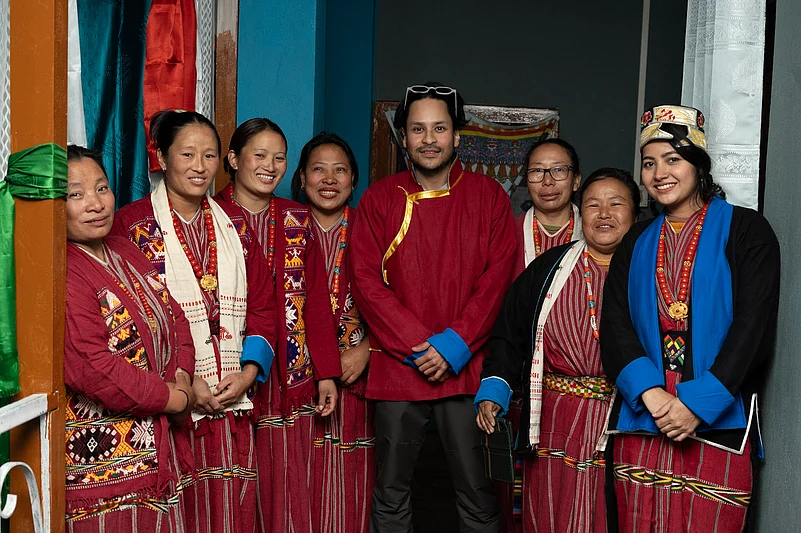 Nishant Sinha (centre) and Farah Naaz (right) along with community members during the launch of the fine dining initiative