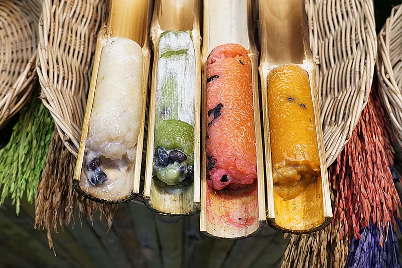 Cracking open the bamboo tubes to eat khao lam