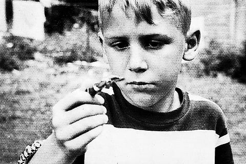 Holding his first snake in Hoosik, New York, 1947